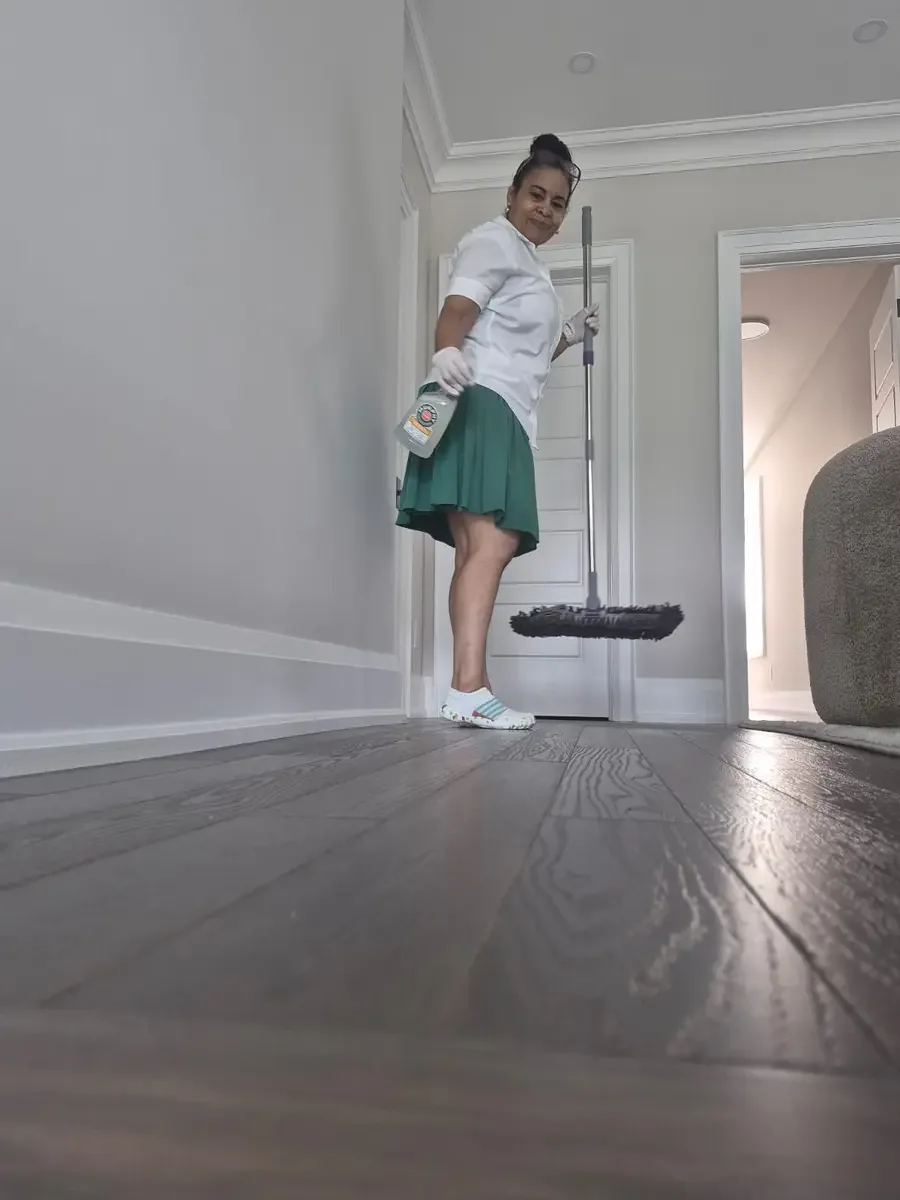 Fresh & Shiny cleaner providing surface-appropriate hardwood-floor care during weekly house cleaning in Ajax.
