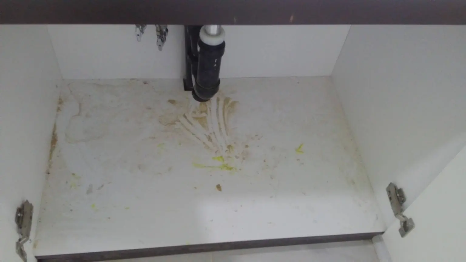 Dirty cabinet interior before basement renovation cleaning in Ajax