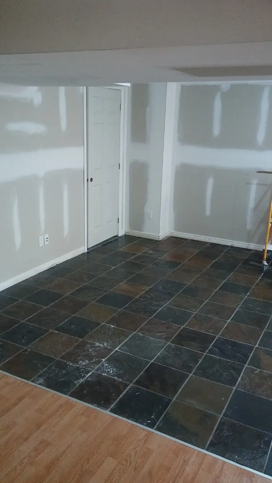 Construction dust on tile flooring before post-construction cleaning in Whitby