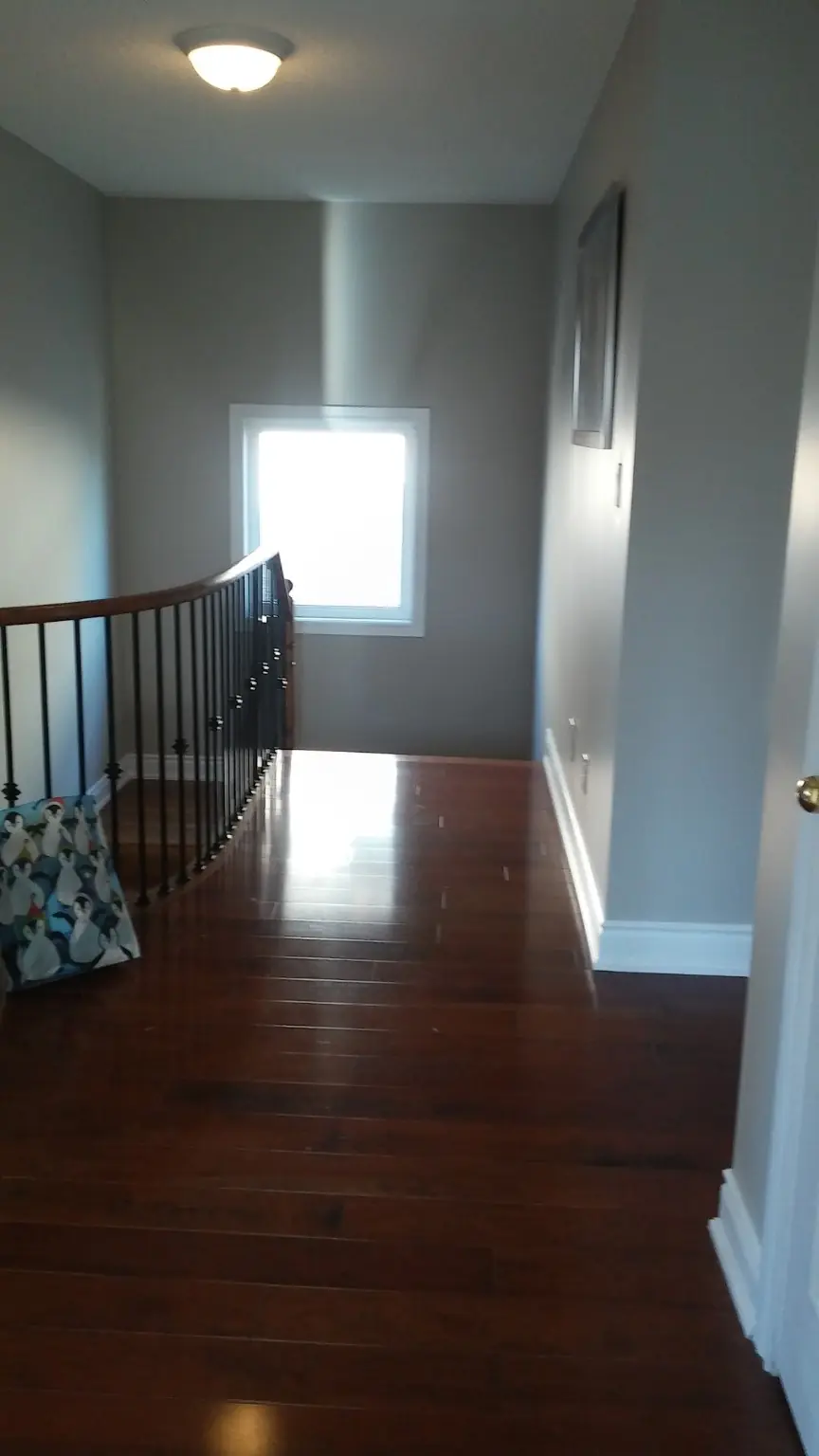 Clean hardwood staircase landing after deep cleaning in Ajax